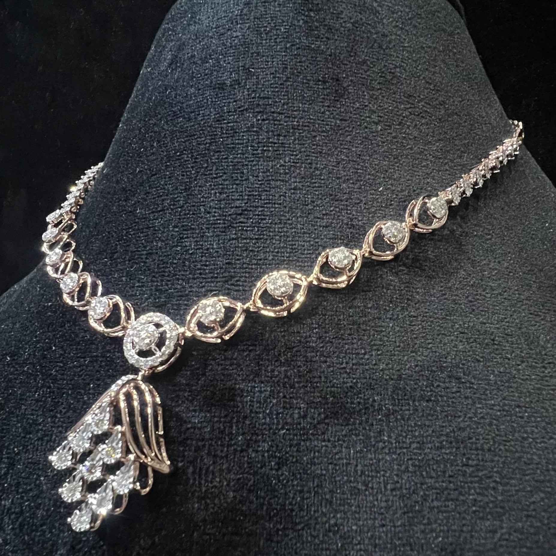 Radiant cascade diamond necklace set displayed on black velvet bust