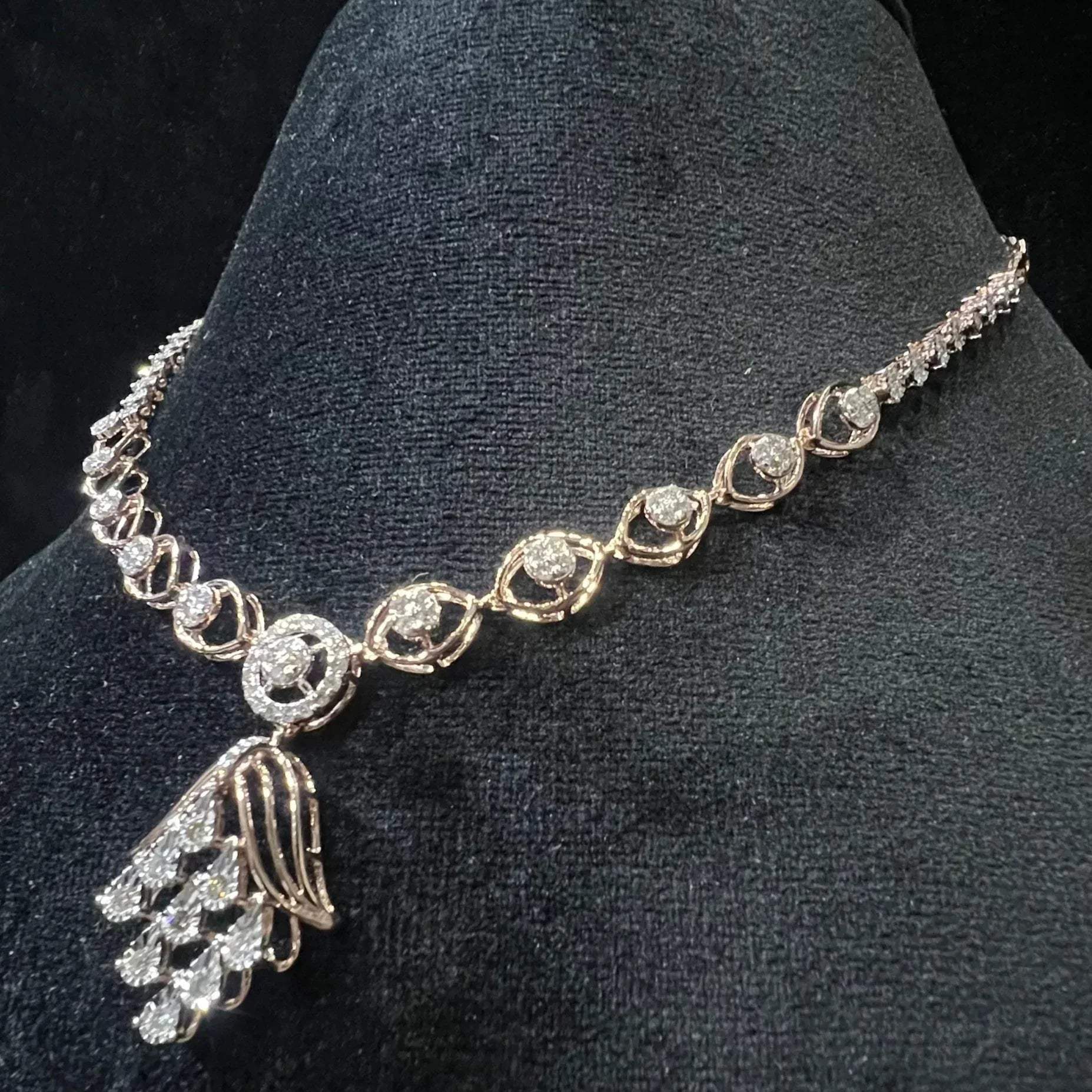 Radiant cascade diamond necklace set displayed on black velvet bust