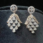 Radiant cascade diamond earrings displayed on black velvet bust