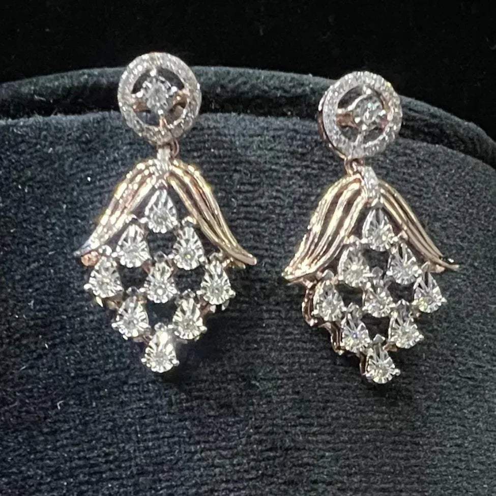 Radiant cascade diamond earrings displayed on black velvet bust