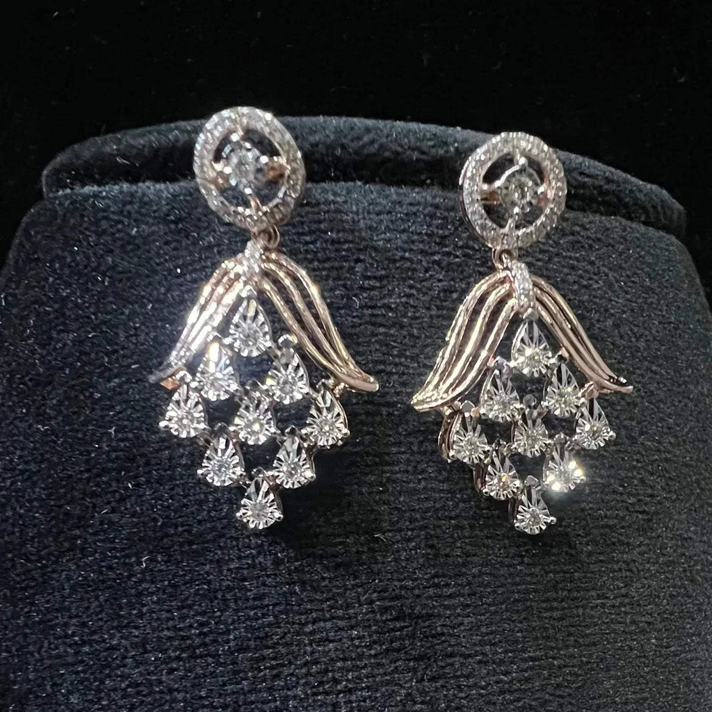 Radiant cascade diamond earrings displayed on black velvet bust