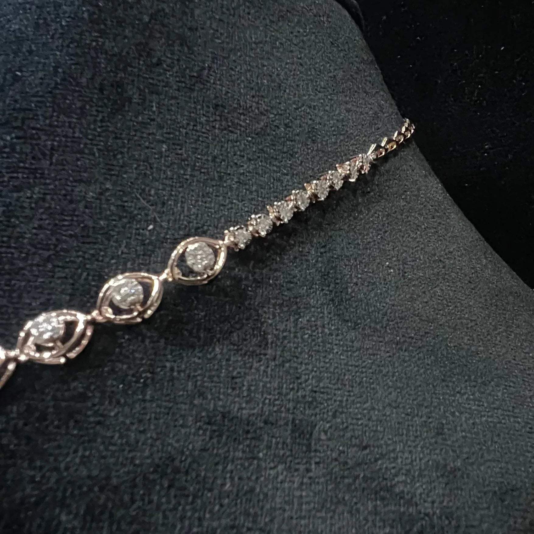 Radiant cascade diamond necklace set from side angle displayed on black velvet bust