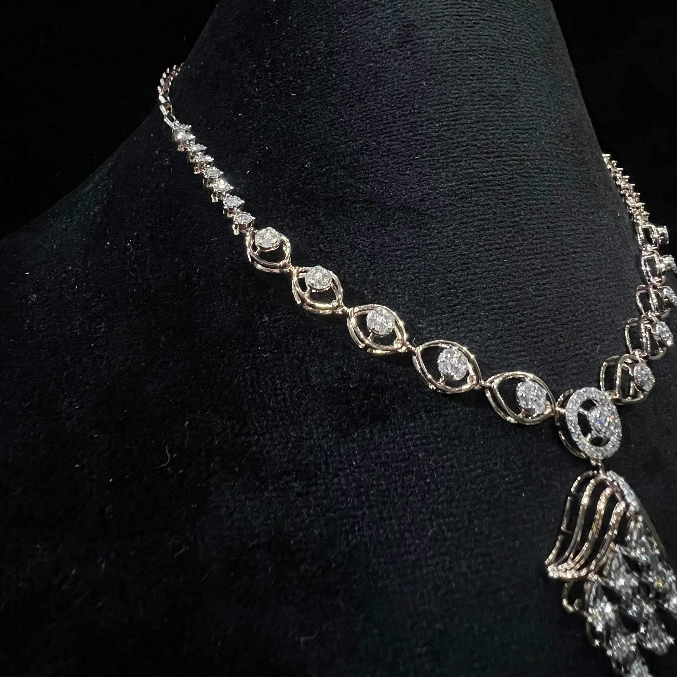 Radiant cascade diamond necklace set displayed on black velvet bust