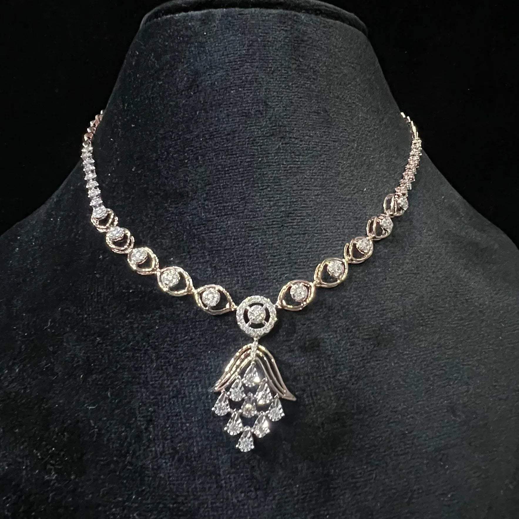 Radiant cascade diamond necklace set displayed on black velvet bust