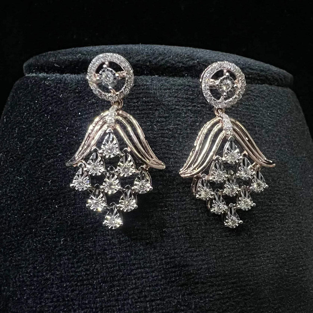 Radiant cascade diamond earrings displayed on black velvet bust