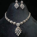 A gold diamond necklace with a geometric pattern and a pair of matching earrings, displayed on a black mannequin bust.