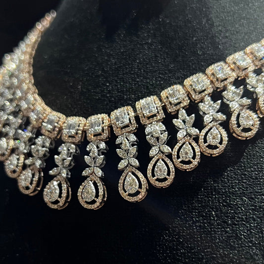 Luxury floral motif diamond necklace set with matching drop earrings on a mannequin bust.