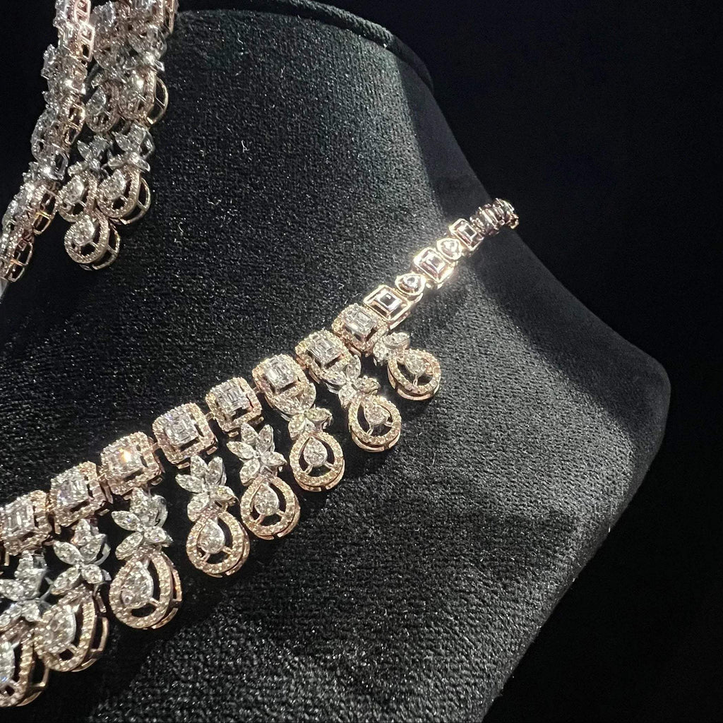 Luxury floral motif diamond necklace set with matching drop earrings on a mannequin bust.