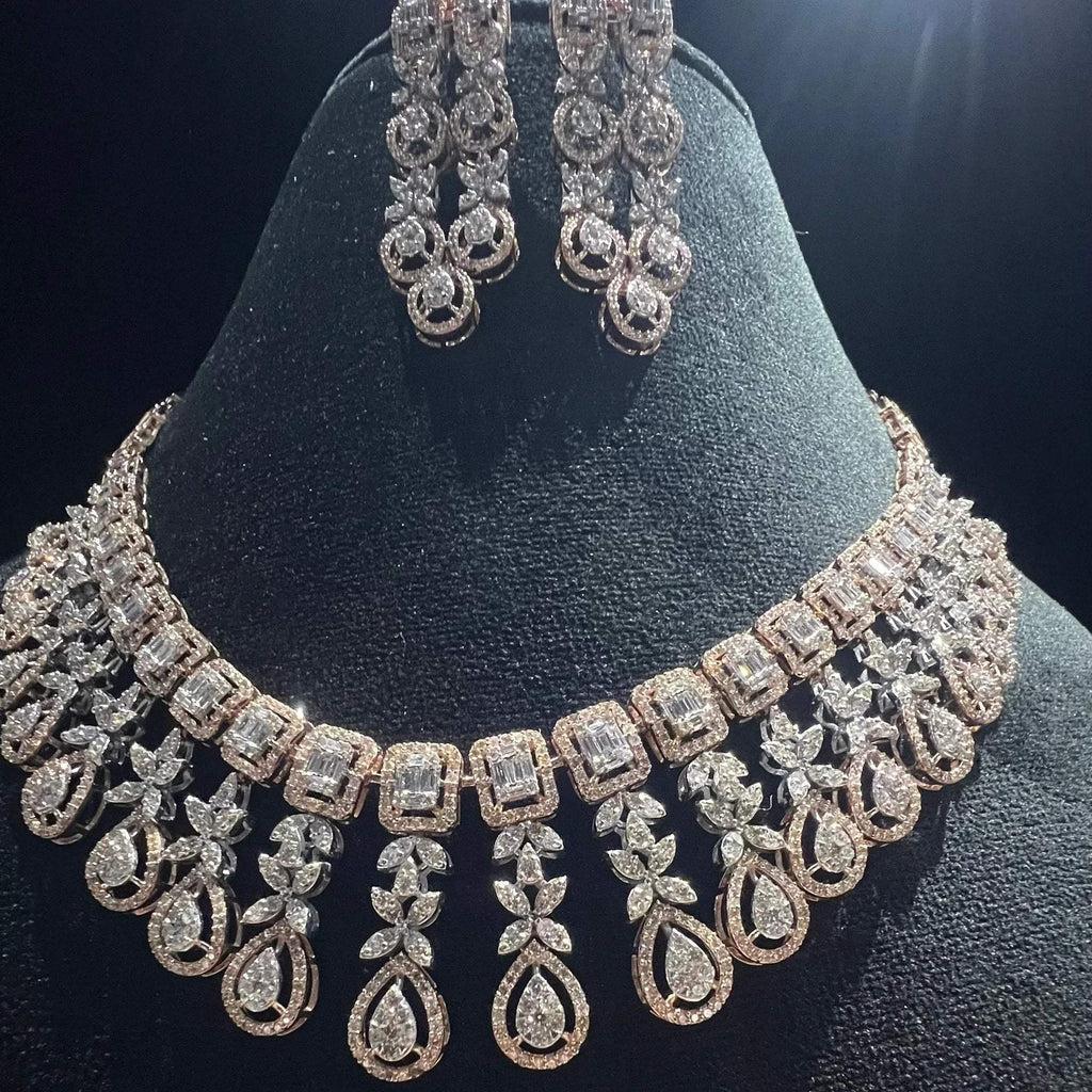 Luxury floral motif diamond necklace set with matching drop earrings on a mannequin bust.