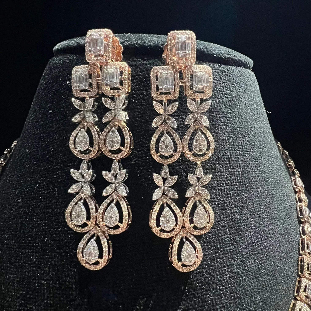 Luxury floral motif diamond necklace set with matching drop earrings on a mannequin bust.