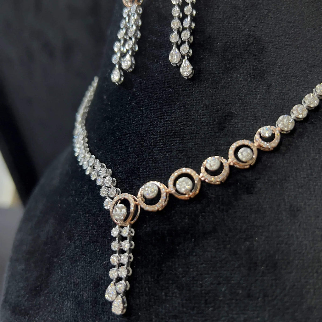 Diamond necklace set with circular motif design and matching drop earrings, featuring sparkling stones in elegant modern style.
