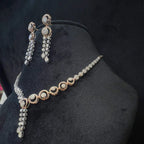 Diamond necklace set with circular motif design and matching drop earrings, featuring sparkling stones in elegant modern style.