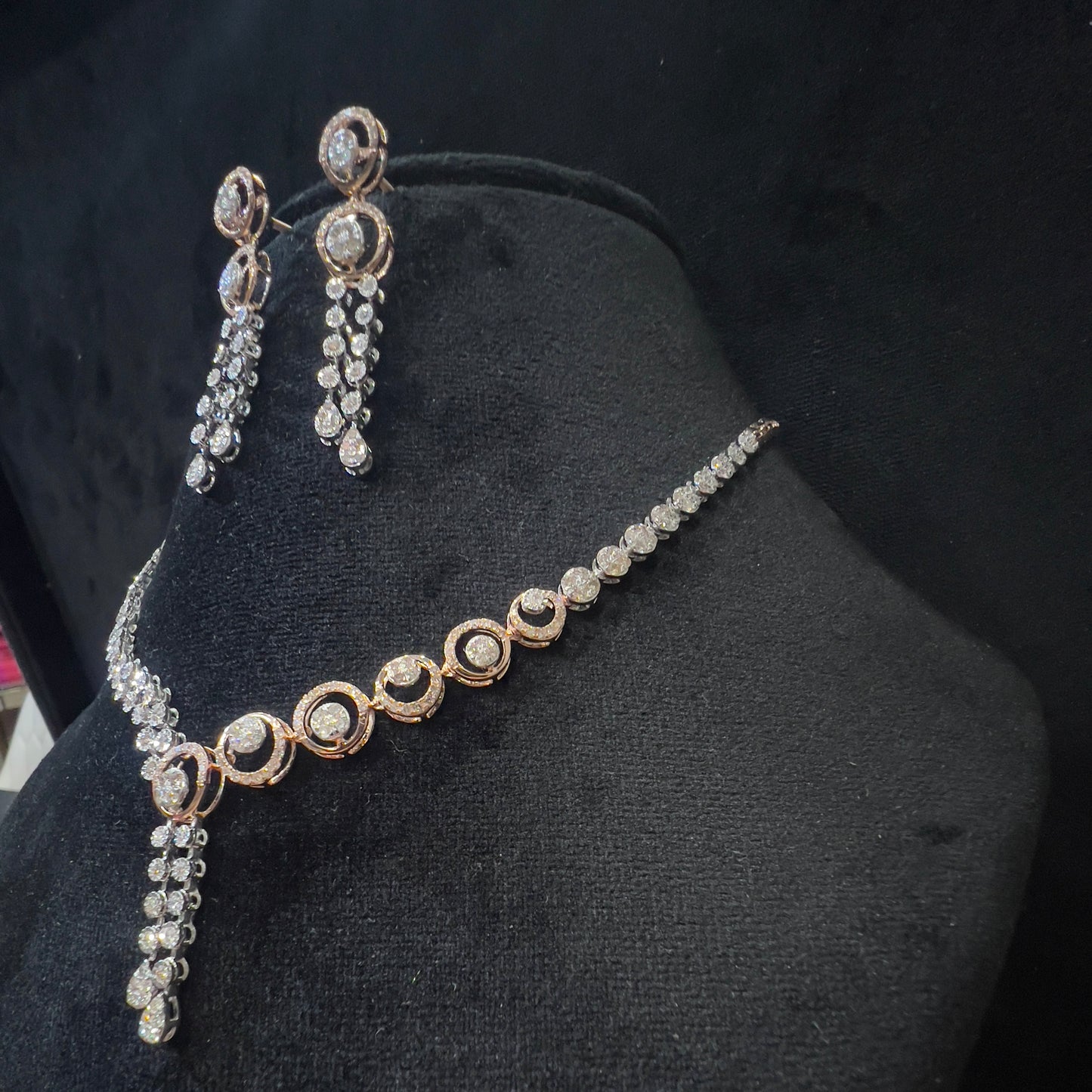 Diamond necklace set with circular motif design and matching drop earrings, featuring sparkling stones in elegant modern style.