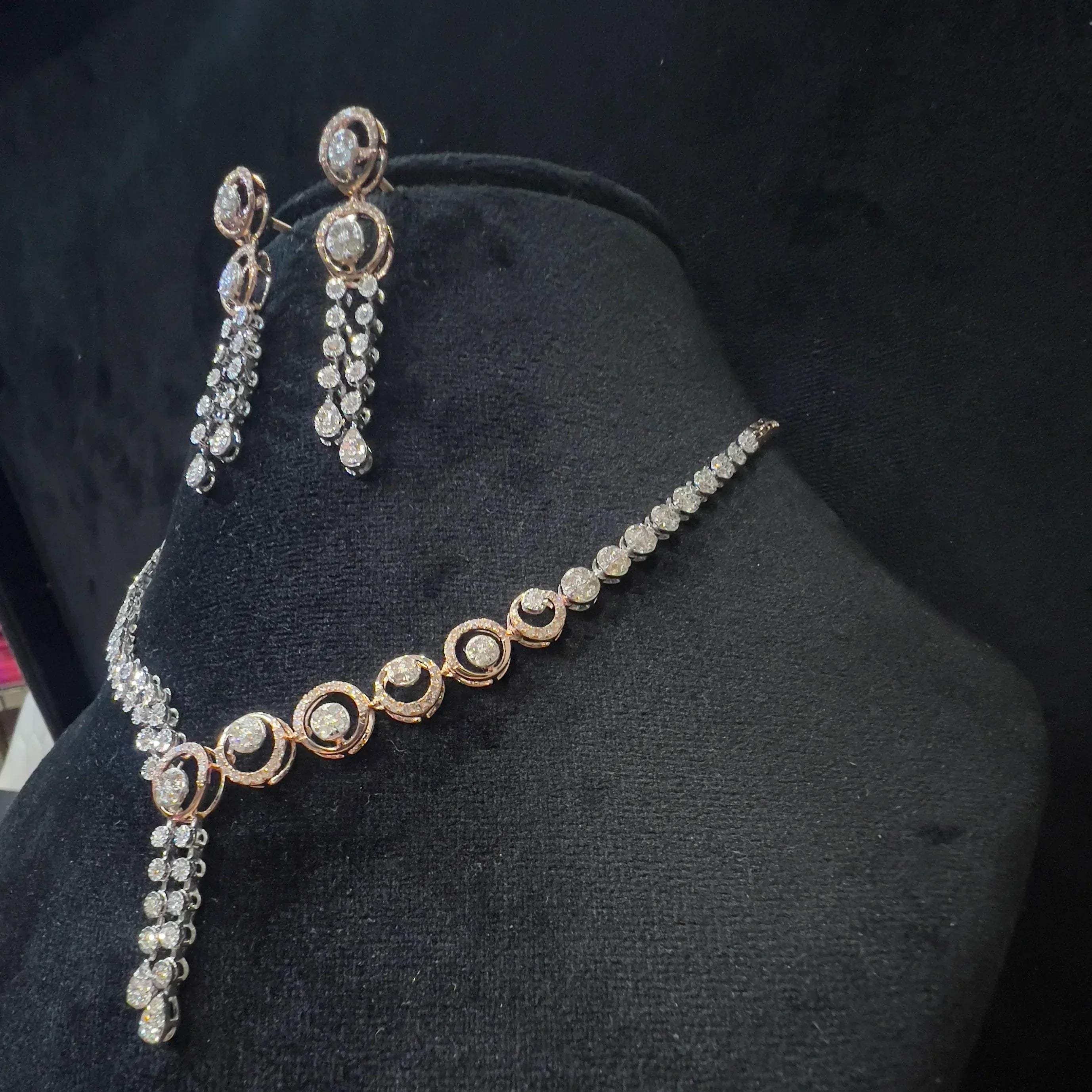 Diamond necklace set with circular motif design and matching drop earrings, featuring sparkling stones in elegant modern style.
