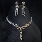 Diamond necklace set with circular motif design and matching drop earrings, featuring sparkling stones in elegant modern style.