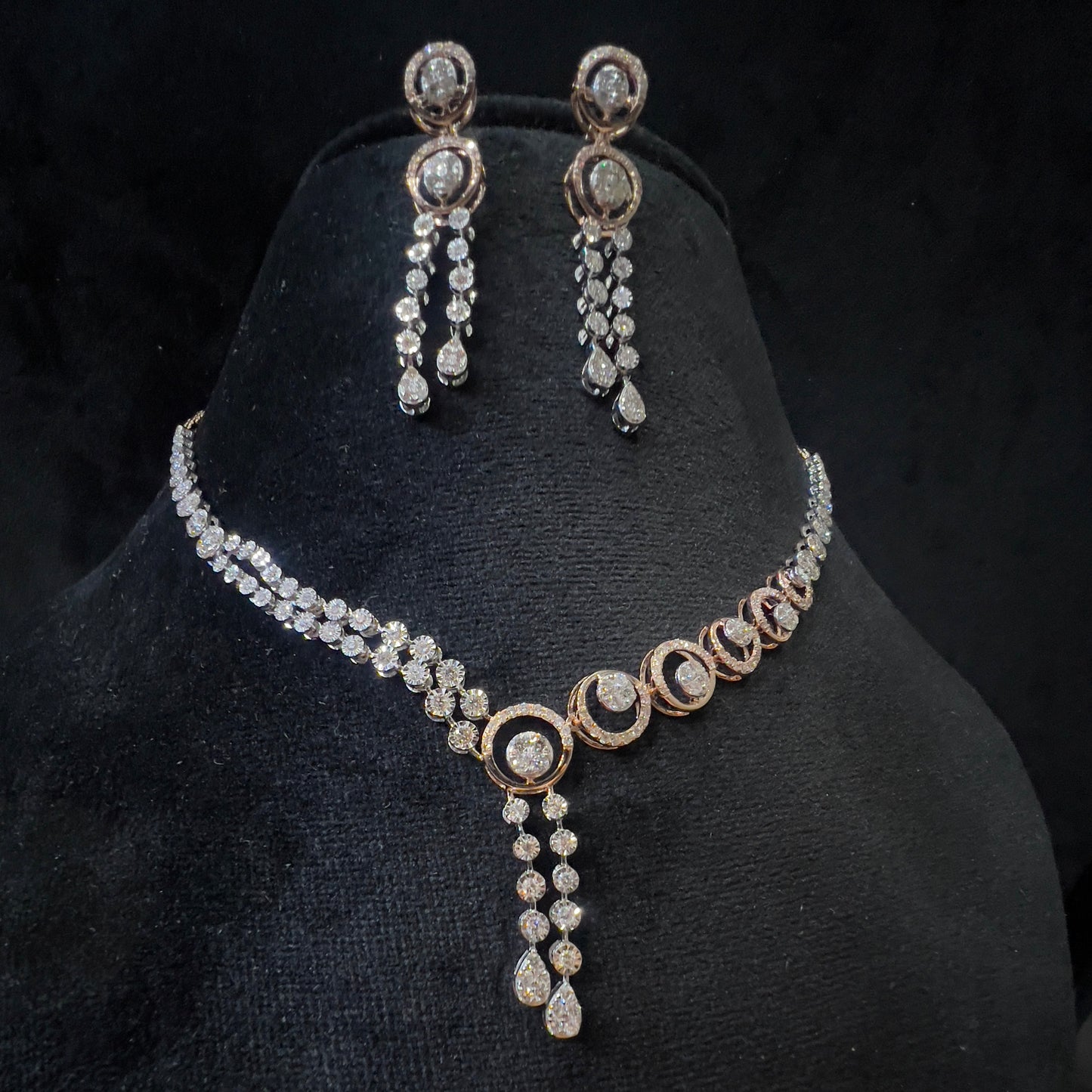 Diamond necklace set with circular motif design and matching drop earrings, featuring sparkling stones in elegant modern style.
