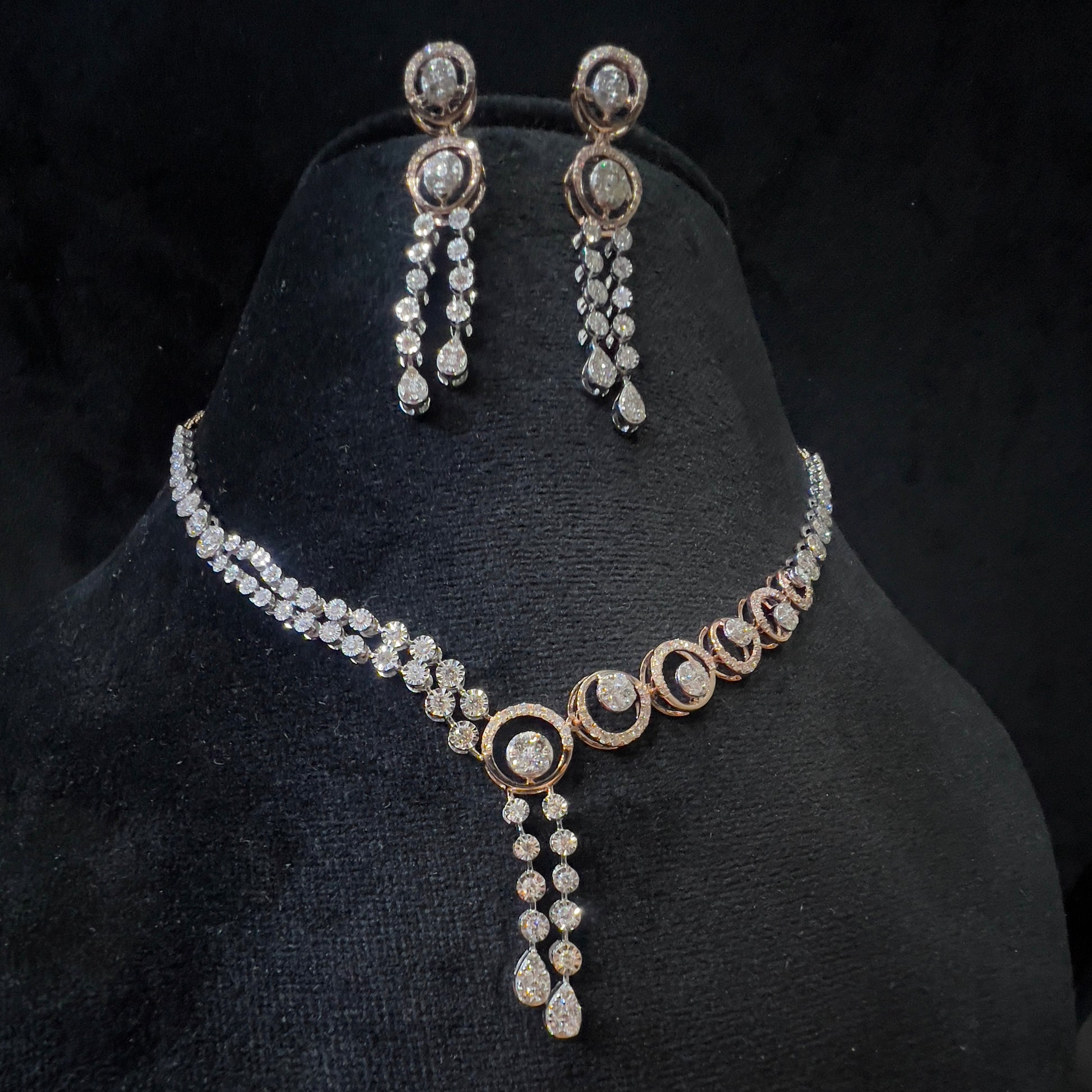 Diamond necklace set with circular motif design and matching drop earrings, featuring sparkling stones in elegant modern style.