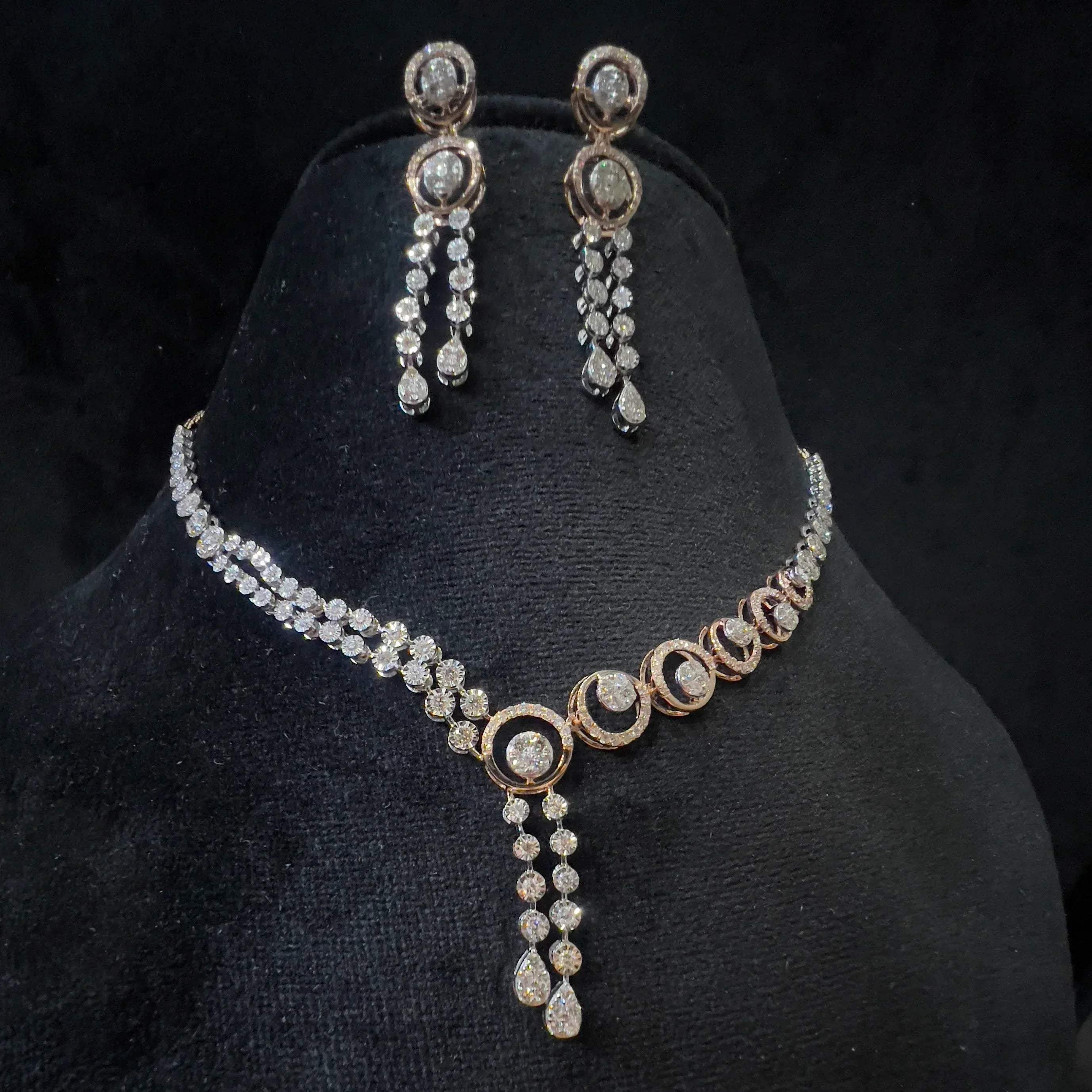 Diamond necklace set with circular motif design and matching drop earrings, featuring sparkling stones in elegant modern style.