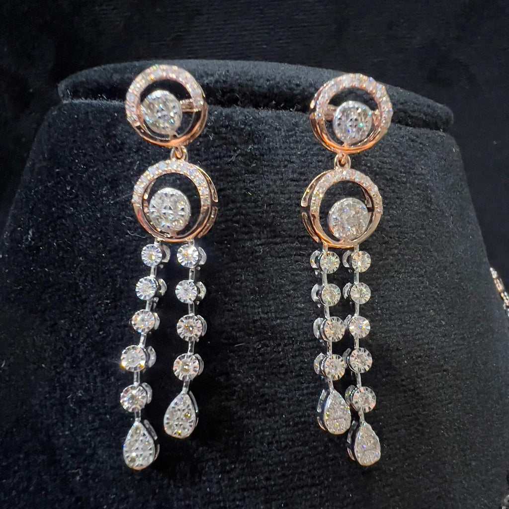 Diamond drop earrings with circular motif design, featuring sparkling stones in elegant modern style.