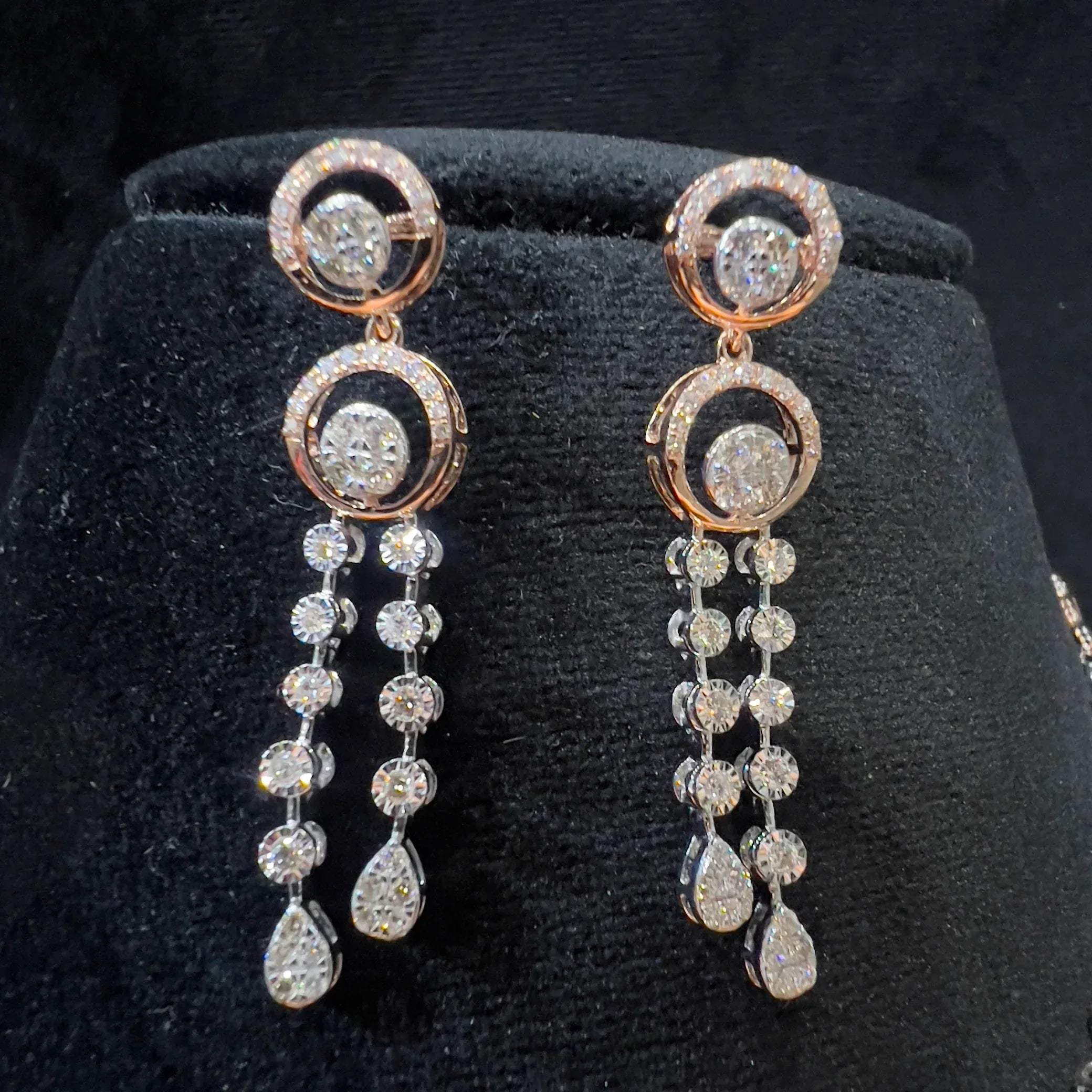 Diamond drop earrings with circular motif design, featuring sparkling stones in elegant modern style.
