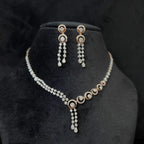 Diamond necklace set with circular motif design and matching drop earrings, featuring sparkling stones in elegant modern style.