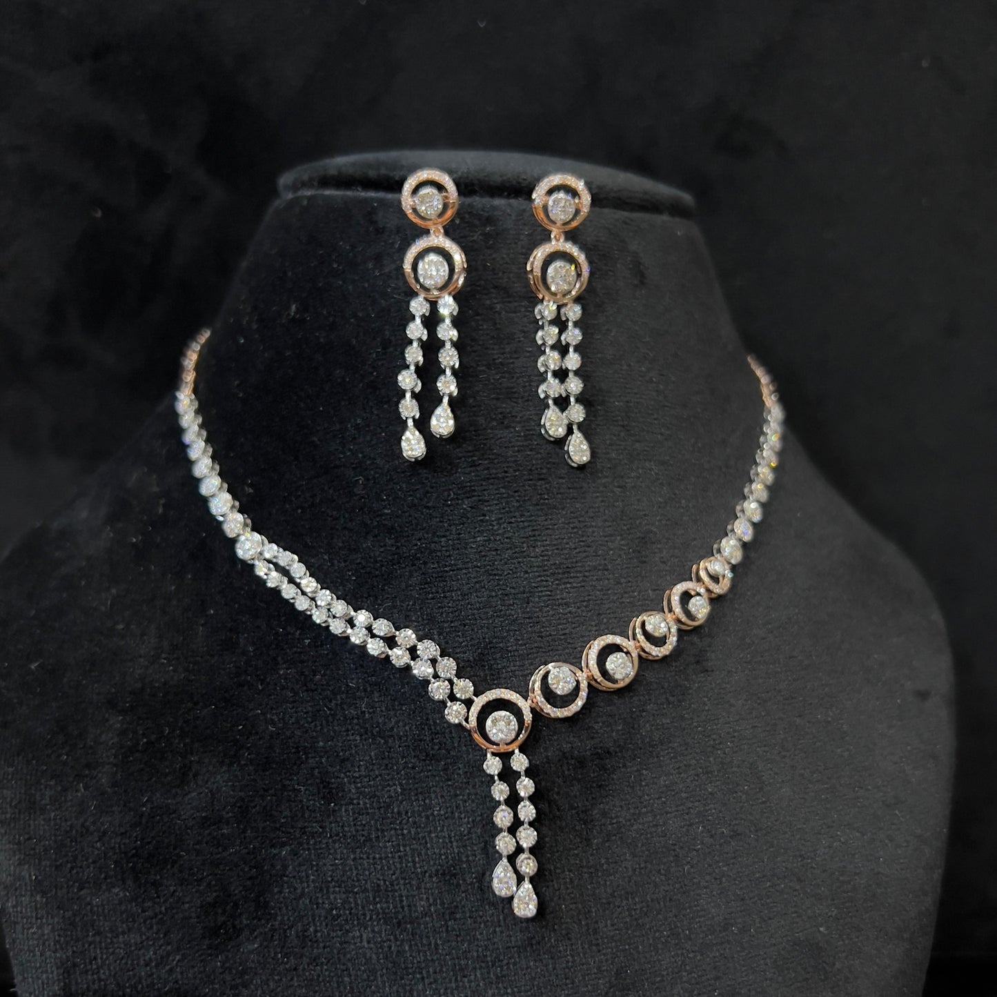 Diamond necklace set with circular motif design and matching drop earrings, featuring sparkling stones in elegant modern style.