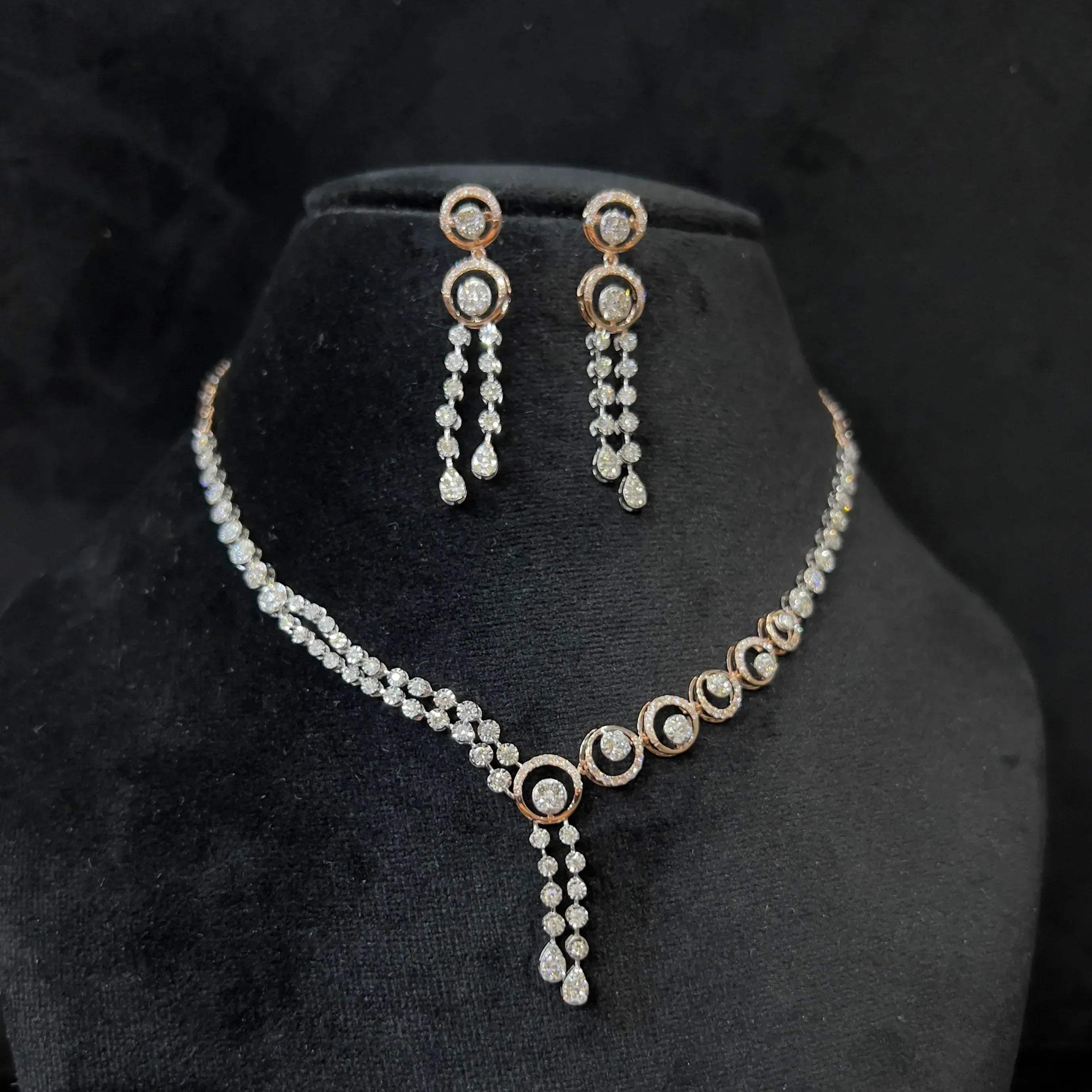 Diamond necklace set with circular motif design and matching drop earrings, featuring sparkling stones in elegant modern style.