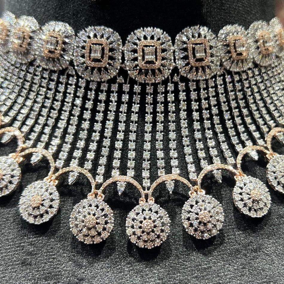 Close-up of a luxurious diamond necklace set with matching earrings featuring circular motifs and cascading diamond strands on a black display stand.