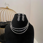 Eternal Knot Cascade diamond necklace set with matching earrings featuring layered diamond strands displayed on a mannequin.