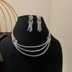 Eternal Knot Cascade diamond necklace set with matching earrings featuring layered diamond strands displayed on a mannequin.