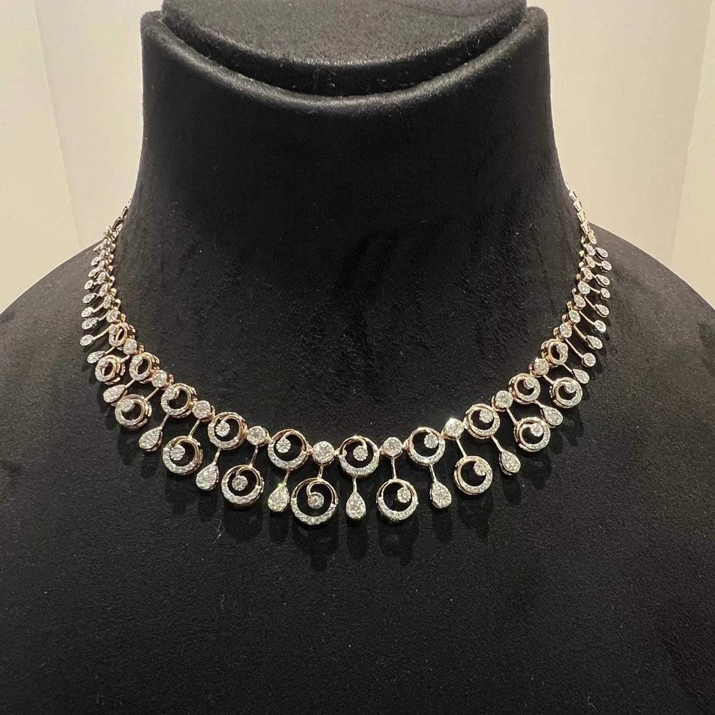 A gold diamond necklace displayed on a mannequin bust, featuring a floral design with intricate detailing and adorned with genuine diamonds.