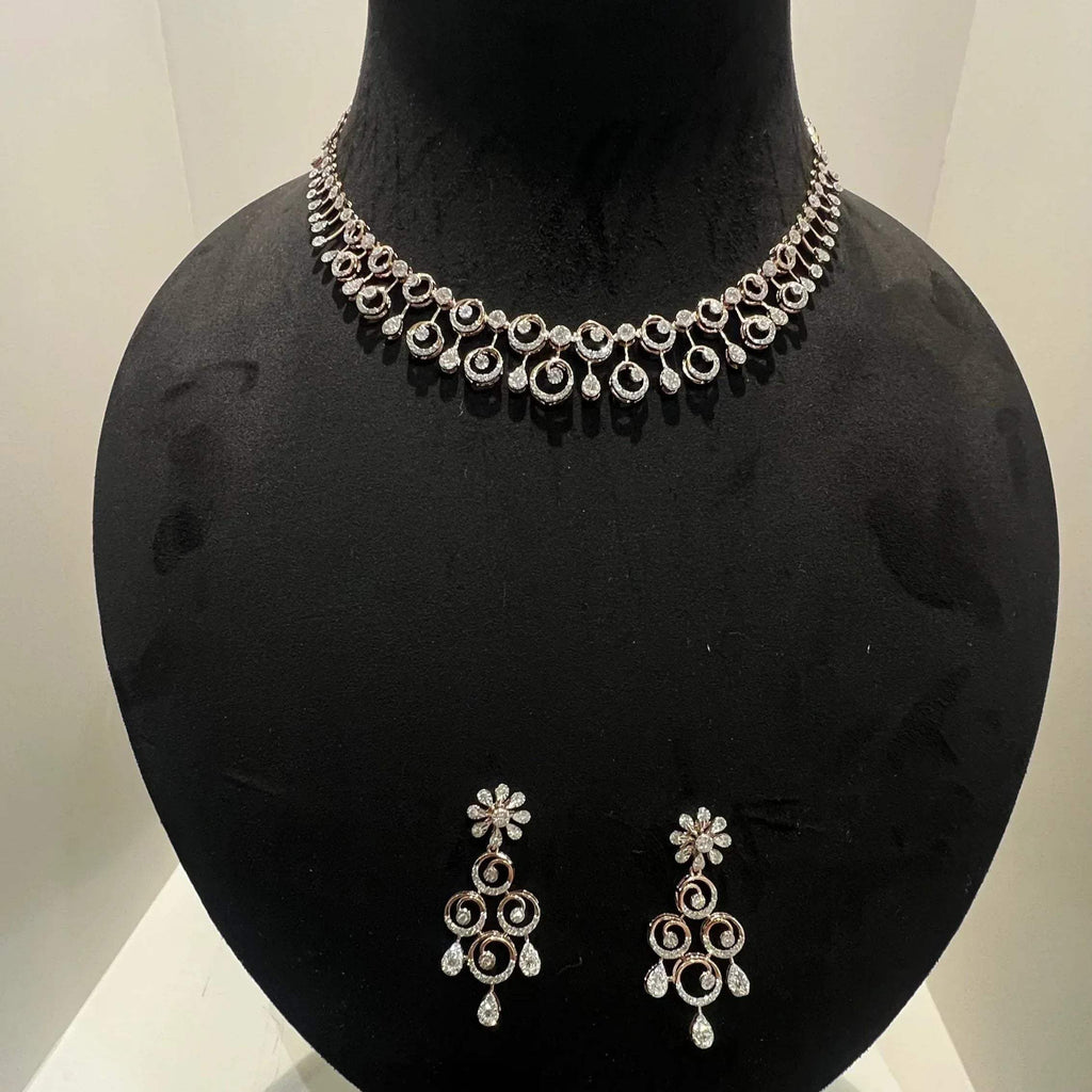 A gold diamond necklace and earrings set displayed on a mannequin bust, featuring a floral design with intricate detailing and adorned with genuine diamonds.