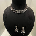 A gold diamond necklace and earrings set displayed on a mannequin bust, featuring a floral design with intricate detailing and adorned with genuine diamonds.