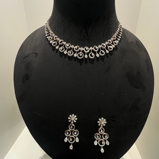 A gold diamond necklace and earrings set displayed on a mannequin bust, featuring a floral design with intricate detailing and adorned with genuine diamonds.