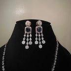 A gold diamond necklace with a matching set of earrings, featuring a series of round and marquise shaped diamonds set in a classic design on a mannequin bust.