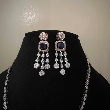 A gold diamond necklace with a matching set of earrings, featuring a series of round and marquise shaped diamonds set in a classic design on a mannequin bust.