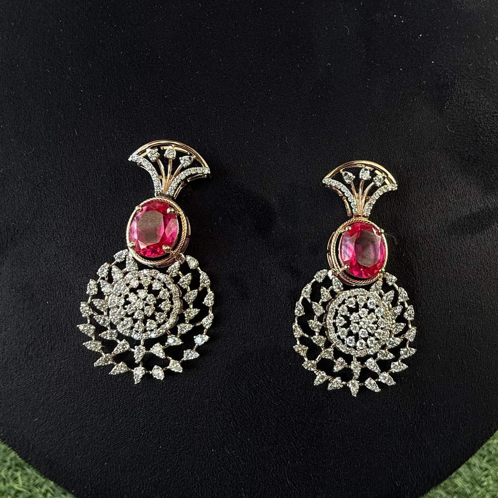 gold diamond earrings with a floral pattern and red and white diamonds, displayed on a mannequin.