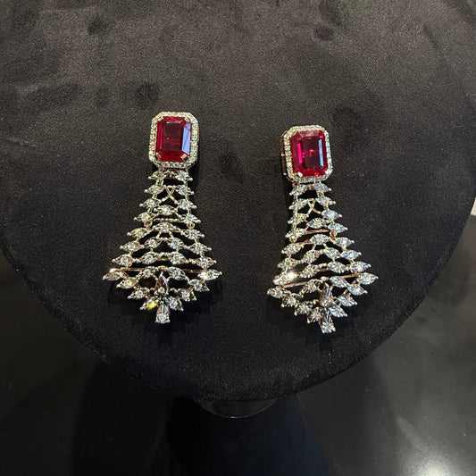 Color stone and diamond earrings is displayed on a mannequin.
