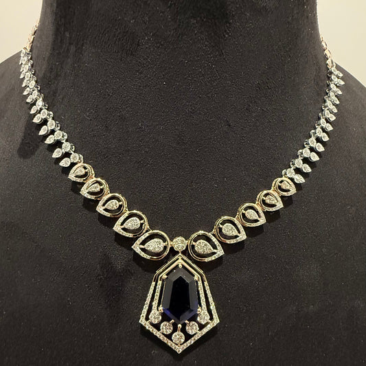 A gold diamond necklace with a geometric pendant displayed on a mannequin bust.