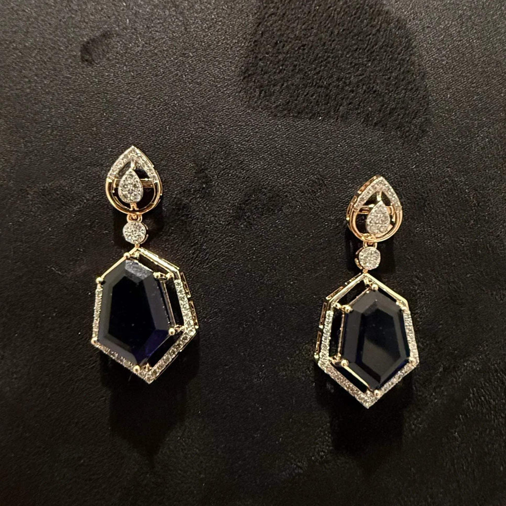 A gold diamond necklace with a geometric pendant and matching earrings displayed on a mannequin bust.