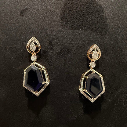 A gold diamond necklace with a geometric pendant and matching earrings displayed on a mannequin bust.