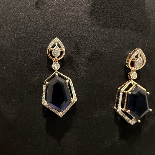 A gold diamond necklace with geometric matching earrings displayed on a mannequin bust.