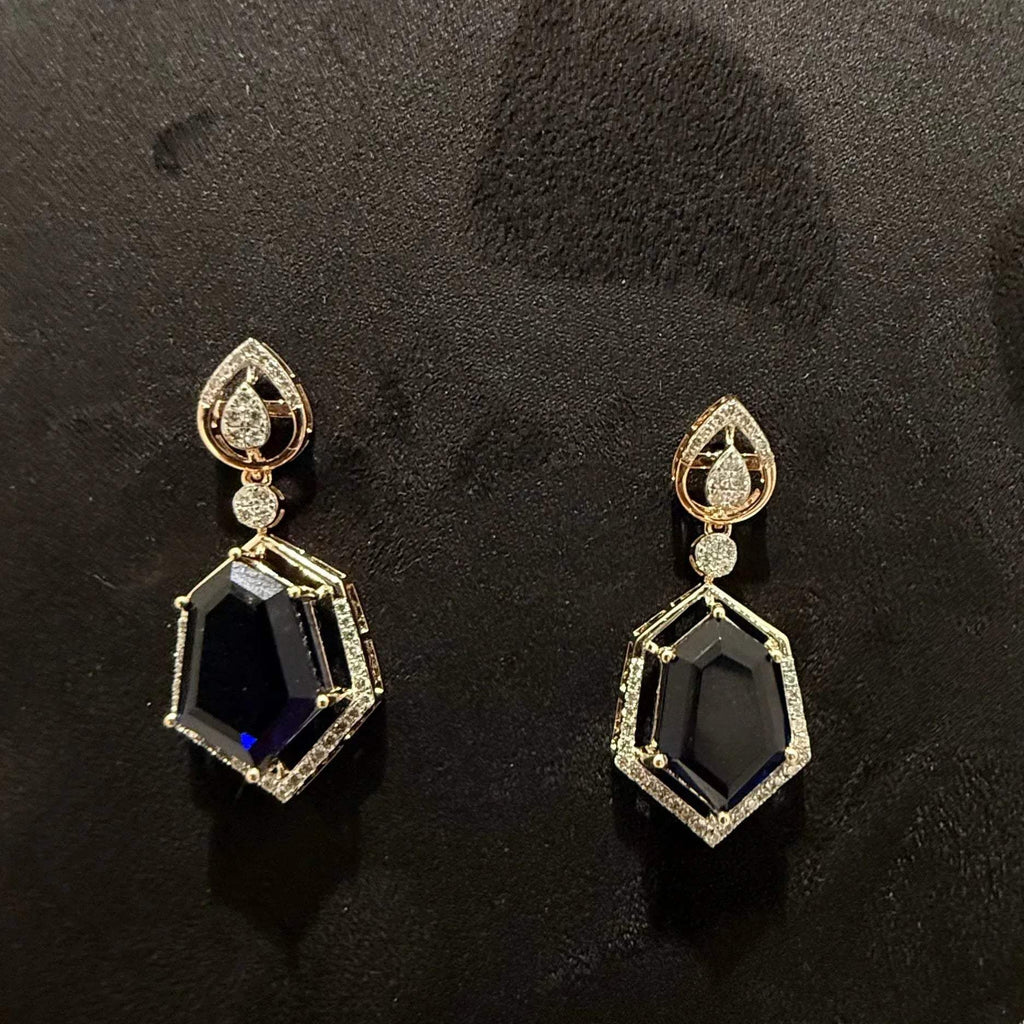 A gold diamond necklace with geometric matching earrings displayed on a mannequin bust.