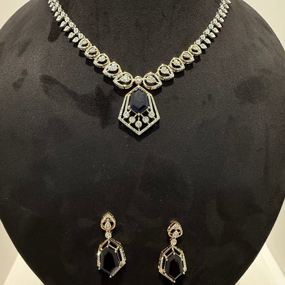 A gold diamond necklace with a geometric pendant and matching earrings displayed on a mannequin bust.