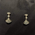 A luxurious gold diamond necklace with earrings set, displayed on a mannequin bust.