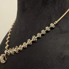 A luxurious gold diamond necklace with earrings set, displayed on a mannequin bust.