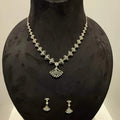 A luxurious gold diamond necklace with earrings set, displayed on a mannequin bust.