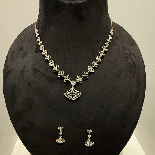 A luxurious gold diamond necklace with earrings set, displayed on a mannequin bust.
