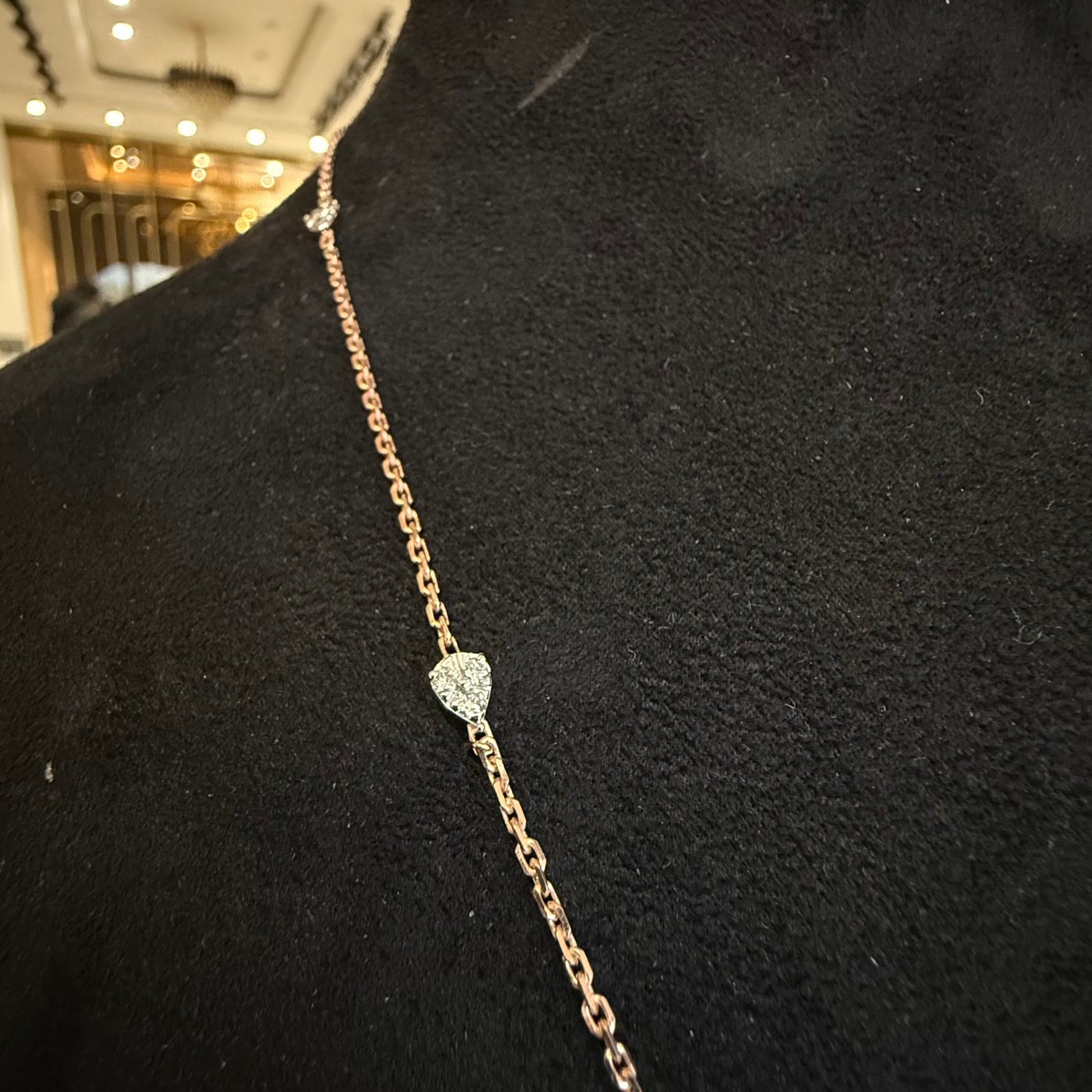 Modern diamond chain necklace set with hexagon pendant on display.