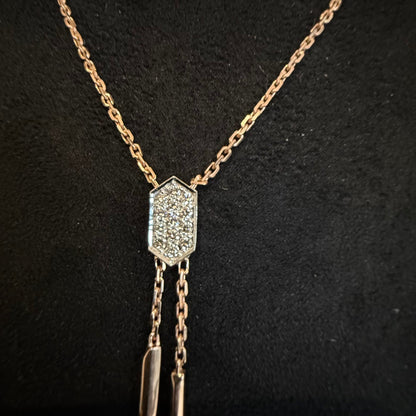 Modern diamond necklace set with hexagon pendant on display.